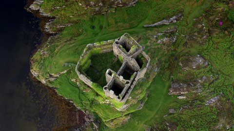 A drone shot of Castle Tioram a ruined castle that sits on the tidal island Eilean Tioram in Loch Moidart, Lochaber, Highland, Scotland