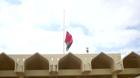 Oman flag Downing .The national flag of Oman consists of three stripes (white, green and red) with a red bar on the left that contains the national emblem of Oman ( Dagger and two swords ) .