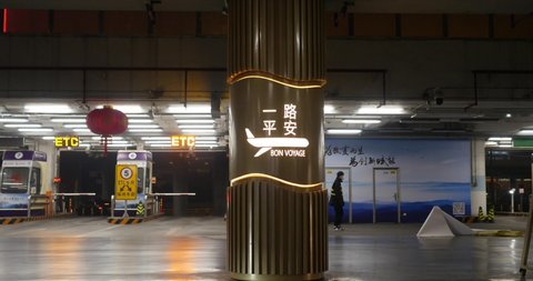 24-01-2020 - In Beijing airport, China. pillar with "bon voyage" have a good trip message written in Chinese and french. with luminous plane. seing this would bring luck to the asian plane passengers 
