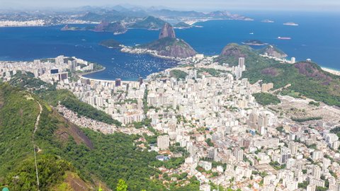 Tilting up aerial timelapse hyperlapse of the Sugarloaf mountain in Rio de Janeiro, Brazil. View of Ipanema, Copacabana, Botafogo. Boats and ships traffic in Guanabara bay. Peak and hills.