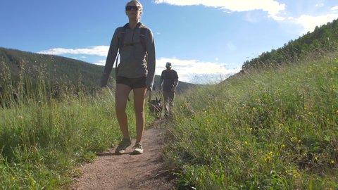 Young Couple Hike Colorado Mountain Trail with Dog on Leash