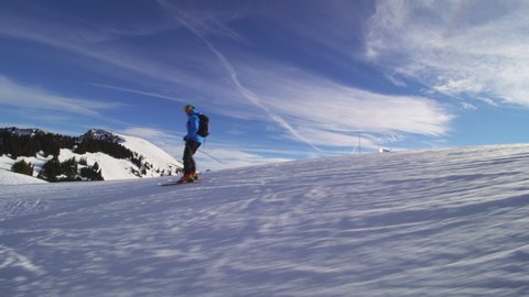 professional skier skiing on slopes in the Swiss alps and throwing snow at the camera