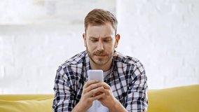 upset man making online bets on smartphone