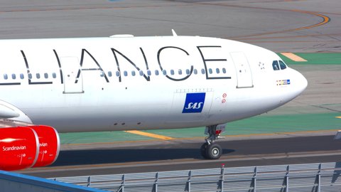 SAN FRANCISCO, CA - 2020: SAS Scandinavian Airlines Airbus A340 Jet Airliner with Star Alliance Livery Close-up Panning on Tarmac during Taxiing at SFO International Airport on a Sunny California Day