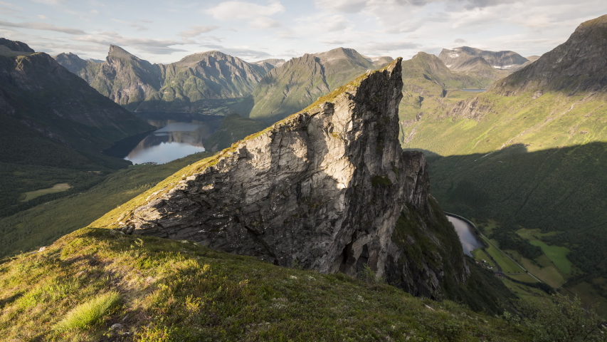 On the edge, sharp mountain peak on warm light