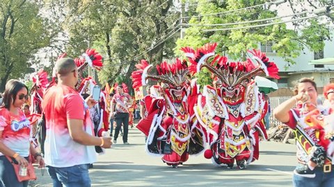 Concepcion De La Vega, DOMINICAN REPUBLIC - FEBRUARY 18, 2019: men in flamboyant demon costumes pass by on city street at dominican carnival on February 18 in Concepcion De La Vega
