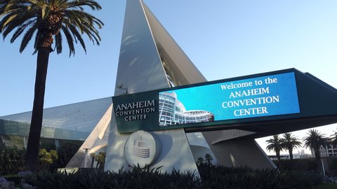 Anaheim, CA / USA - July 22, 2019: Anaheim Convention Center as seen from the west, pan from Welcome signage and palm tree to building