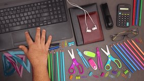 Man scrolling with finger on touch pad on modern laptop on desk with business supplies - Stop motion
