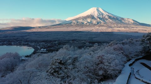 Mount Fuji: Aerial view of Fujiyama in winter, snow covered scenery with freezing fog on trees. landscape panorama of Japan from above, Asia