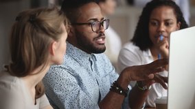 Confident smart african american manager in eyeglasses explaining corporate software details to motivated multiracial female colleagues. Smiling multiracial employees listening to leader instructions. - Powered by Shutterstock - Get 15% off with code: PIKWIZARD15