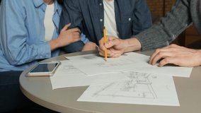 Young couple at a meeting with an interior designer. Placement of kitchen furniture. Architect draws a sketch of an apartment layout 4k - Powered by Shutterstock - Get 15% off with code: PIKWIZARD15