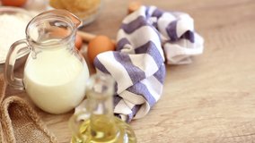 Footage  of ingredients prepared to make pastry. Eggs, milk, flour on table top view shot. Slow motion video. - Powered by Shutterstock - Get 15% off with code: PIKWIZARD15