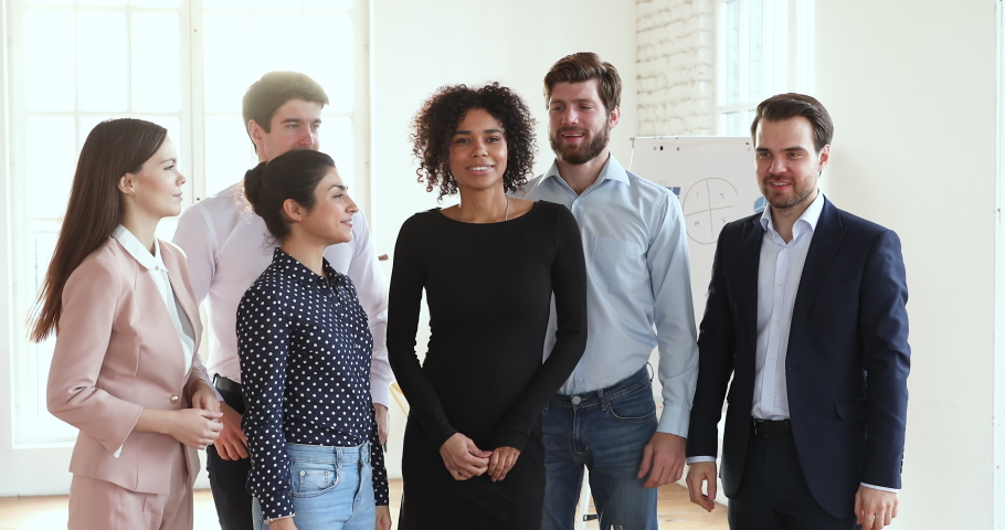 Overjoyed ecstatic friendly professional multiracial team business people group bonding celebrating triumph good teamwork result success together standing in office, rewards and achievements concept | Shutterstock HD Video #1045309069