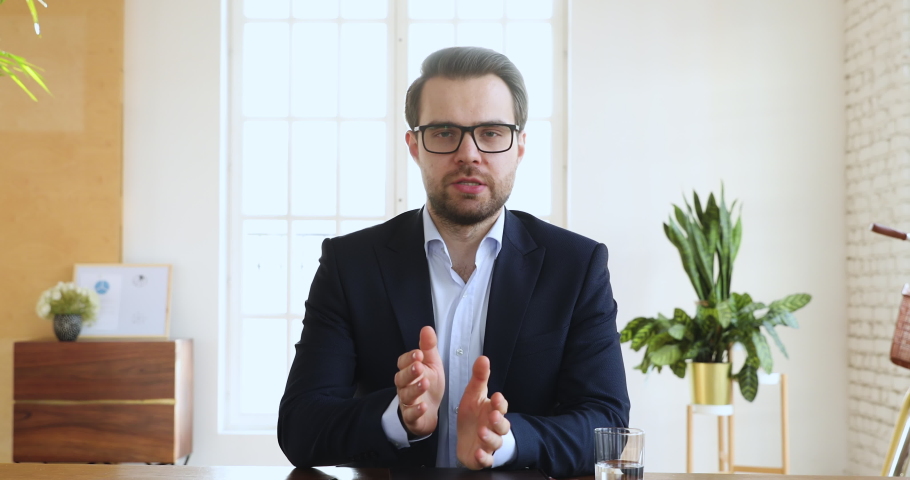 Confident businessman ceo wear suit speaking looking at camera in office, male executive manager talking make conference online video chat call job interview recording online training, web cam view Royalty-Free Stock Footage #1045309180