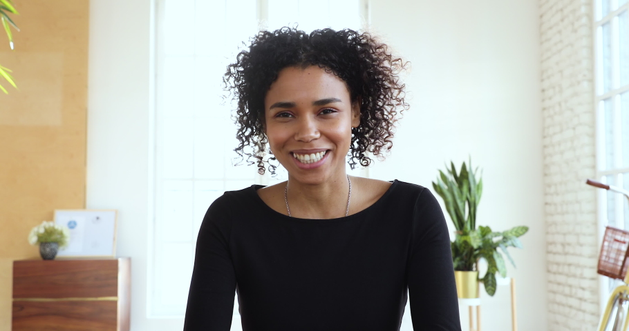Young african business woman make conference call in office, smiling afro american female manager talk look at camera communicating in online video chat, distance job interview concept, webcam view Royalty-Free Stock Footage #1045309192