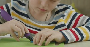 Little kid making mock up by 3d pen, close up video