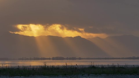 Sunrise Covered By Moving Clouds Over Coromandel Ranges And Firth Of Thames In Miranda, North Island Of New Zealand - Wide Shot
