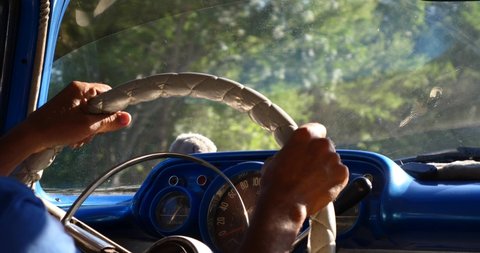 Anonymous Man driving old car in Cuba