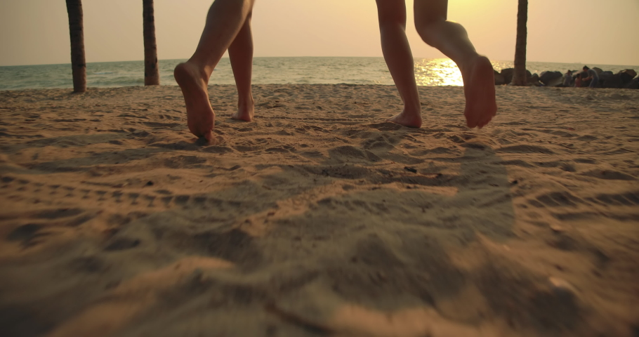 Lens flare, Slow motion: Close up Women friends running enjoy life playing and freedom beach at sunset, Attractive together of asian female traveler with friends people lifestyle. 4K UHD. | Shutterstock HD Video #1045389319
