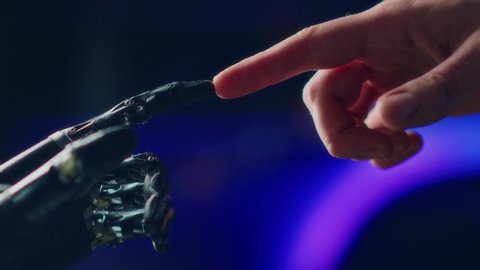 Humanoid Robot Arm Touches Human Hand. Humanity and Artificial Intelligence Unifying Gesture.Technology Merges with Creative Human Mind. Futuristic Concept Inspired by Michelangelo's Creation of Adam