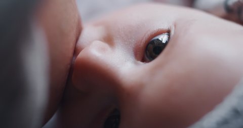 Authentic macro shot of neo mother is breastfeeding her newborn baby in a nursery in a morning.  Shot in 8K. Concept of maternity,healthcare,breastfeeding, motherhood, parenthood, childhood, life