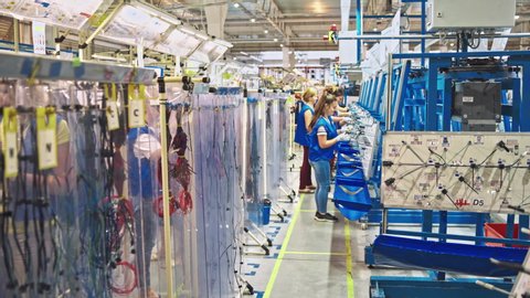 VINNITSA, UKRAINE - OCTOBER 2019: People work in modern workshop, many machines in warehouse