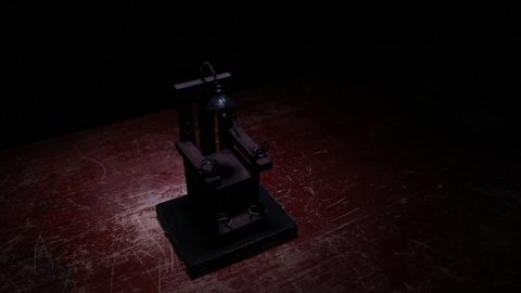 Death penalty electric chair miniature on dark. Creative artwork decoration. Image of an electric chair scale model on a dark backgorund (Slider shot)