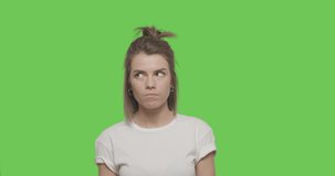 Young pretty girl wear white t-shirt chewing bubble gum over green screen background, Woman winking closing her eyes by hand on chroma Key 4k raw video footage slow motion 60 fps