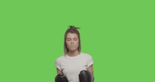 Caucasian girl boxer chewing bubble gum looking at camera. Sporty woman training fighting boxing having fun over Green Screen, Chroma Key. 4k raw video footage slow motion 60 fps
