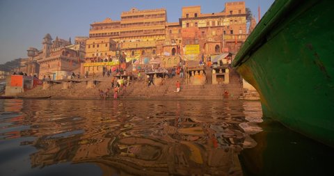 January Varanasi 2020: Tourists and local people on a boat ride at sunrise in the Holy river Ganges, in Varanasi, Uttar Pradesh, India