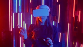Beautiful Young Girl Wearing Virtual Reality Headset Draws Abstract Lines. Creative Young Girl Does Concept Art with Augmented Reality.