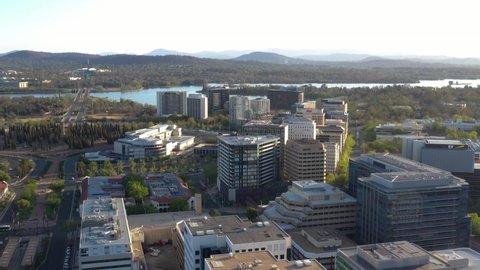 CANBERRA, AUSTRALIA – JANUARY 26, 2020: Aerial view of Canberra City, the capital of Australia, travelling south toward Lake Burley Griffin and Commonwealth Bridge on a sunny afternoon  