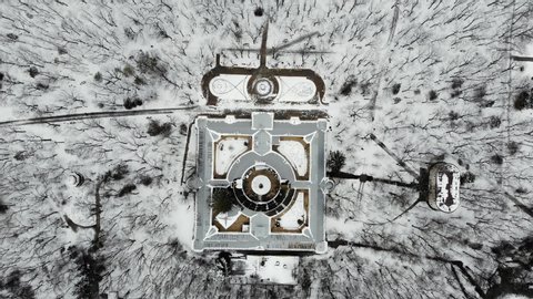 Essentuki, Russia - January 10, 2020: Aerial top down view on abstract building: Upper Nikolaev bath in the Park in winter around the forest.
