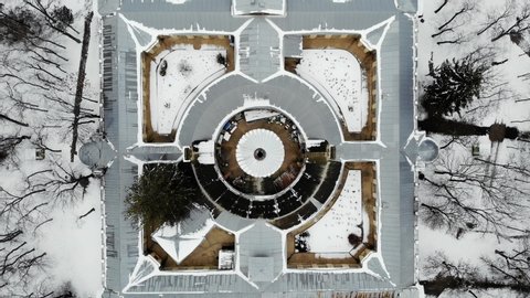 Essentuki, Russia - January 10, 2020: Aerial top down view on abstract building: Upper Nikolaev bath in Park in winter around forest.