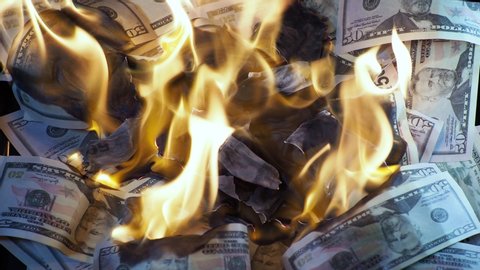 A lot of dollars in the fire, the global financial crisis and inflation, the concept. Lots of burning down dollar bills, burning and Smoking, natural shooting