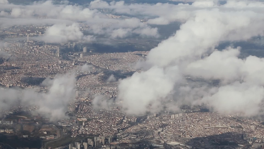 View from the window of the plane at the white clouds in the sky