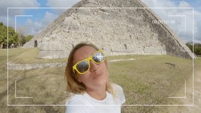 Young woman taking selfie portrait in front of ancient Mayan temple in Mexico having fun exploring while on vacations. Girl filming selfie video while traveling in Central America 