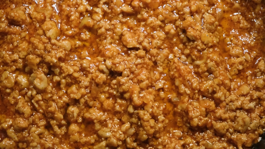 Close-up of meat stewed in sauce. Concept. Minced meat is well fried in large amount of sauce in pan. Professional cooking of minced meat gravy with sauce