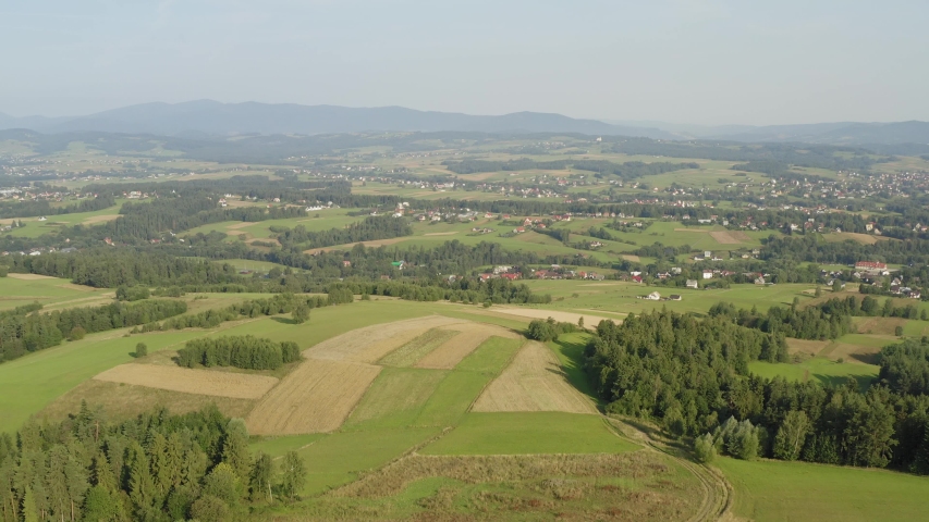Peaceful View of Poland Meadow City And Mountain In Foreground With Beautiful Cloudy Sky in Background - Aerial shot