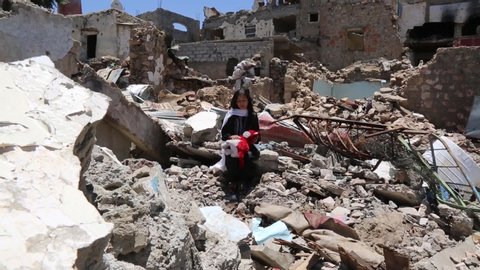 Taiz  Yemen - 13 Apr 2017 : Children in al-Jahmliya neighborhood among the ruins of houses that destroyed by fierce fighting between al-Houthi militia and the national army in Taiz City,Yemen