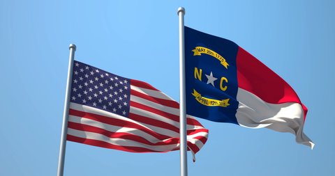 North Carolina flag and the USA on a flagpole realistic wave on wind not synchronously, solid background. The State of North Carolina in The United States of America. Raleigh. Charlotte.