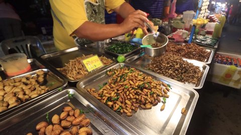 KHAO LAK, THAILAND - 28 JANUARY 2020: Insects, bugs, grubs, and worms sold as food at night street market  