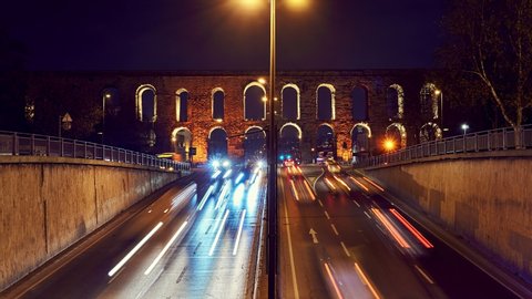 Time lapse clip near Valens Aqueduct (Bozdogan Su Kemeri) in evening with traffic of cars, Istanbul, Turkey. It was a water-providing system of the Eastern Roman capital Constantinpole