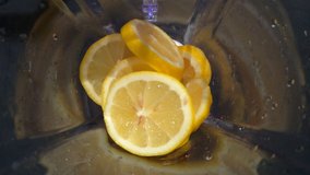 Preparing Infused Water Using Slice Of Fresh Yellow Lemon In Blender For Healthy Organic Food, Drink And Life Consume By Vegetarian Or Common People As A Herbal Nutrition, RAW FUll HD And 4K Video. 