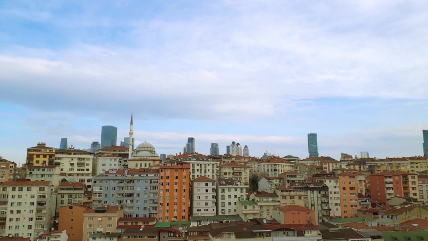 a 10 second full HD 1080p timelapse from the windows over the city of Istanbul in Turkey with white clouds moving in the blue sky at the background above the colorful buildings and houses