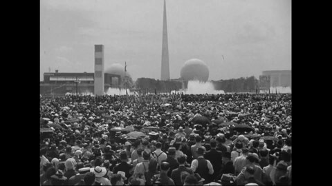 CIRCA 1939 - Albert Einstein addresses a large outdoor crowd at the New York World's Fair.