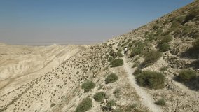 Flying above man walking on Roman trail at Wadi Qelt. Israel. DJI-0195-05