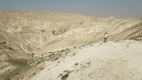 Aerial of man at the view point over Wadi Qelt. Judaean Desert. DJI-0194-07