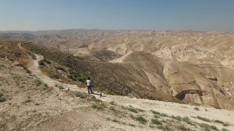 Flying around man at the lookout over Wadi Qelt. Judaean Desert. DJI-0194-04