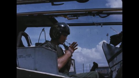 CIRCA 1960s - American soldiers fly in and fire from Huey Cobra Gunship helicopters in South Vietnam.